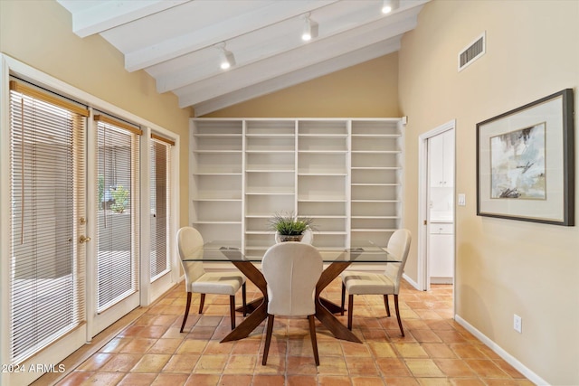 dining area featuring lofted ceiling with beams