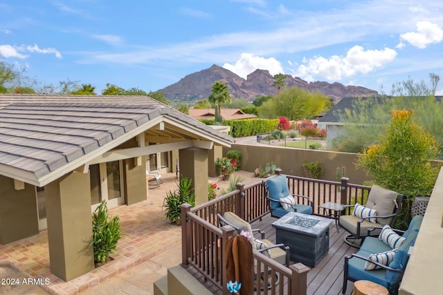 exterior space with a patio area, a mountain view, and an outdoor living space with a fire pit