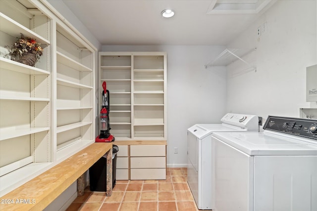 laundry area featuring washing machine and dryer and light tile patterned floors