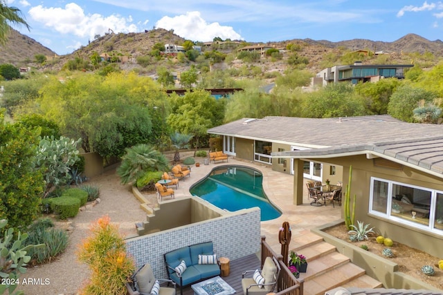 view of swimming pool featuring a mountain view, outdoor lounge area, and a patio