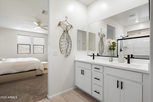17140 W Running Deer Trl, Surprise, AZ 85387 - ensuite bathroom with ceiling fan, double vanity, baseboards, an enclosed shower, and tile patterned floors