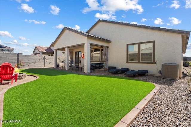 17140 W Running Deer Trl, Surprise, AZ 85387 - back of house with central AC, a patio area, stucco siding, and a fire pit