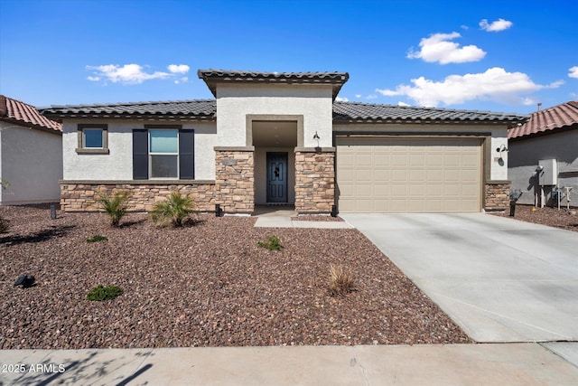 17140 W Running Deer Trl, Surprise, AZ 85387 - view of front of house featuring stone siding, stucco siding, an attached garage, and concrete driveway