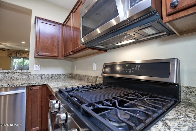 kitchen with light stone countertops and stainless steel appliances