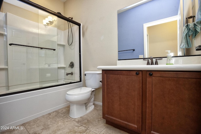 full bathroom featuring shower / bath combination with glass door, tile patterned flooring, vanity, and toilet