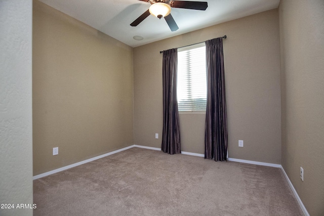 carpeted spare room featuring ceiling fan