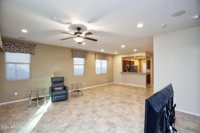 sitting room with light tile patterned floors and ceiling fan