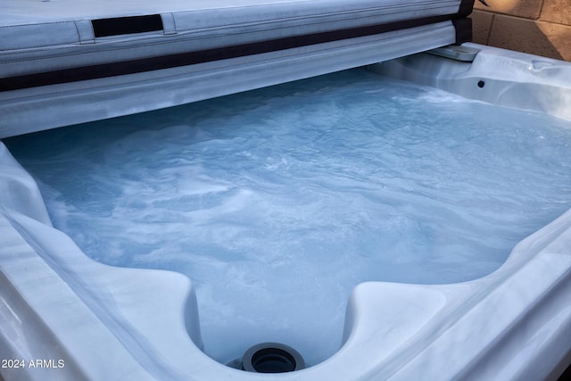 view of pool with a hot tub