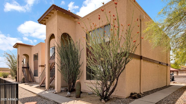 455 N Tegner St Unit 59, Wickenburg, AZ 85390 - view of property exterior with stucco siding and stairway