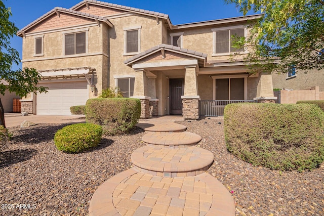 traditional-style home featuring an attached garage, stone siding, a tiled roof, and stucco siding