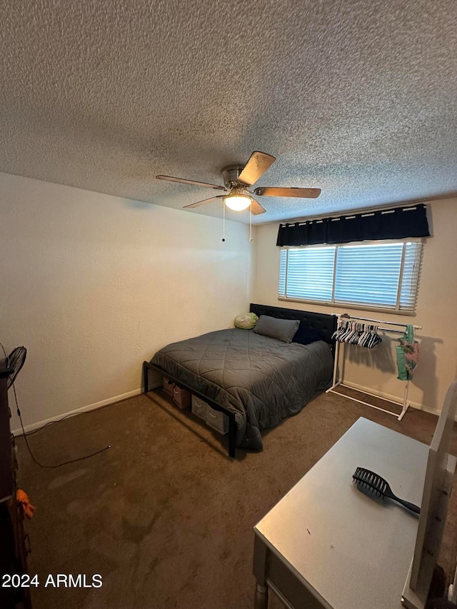 carpeted bedroom with ceiling fan and a textured ceiling