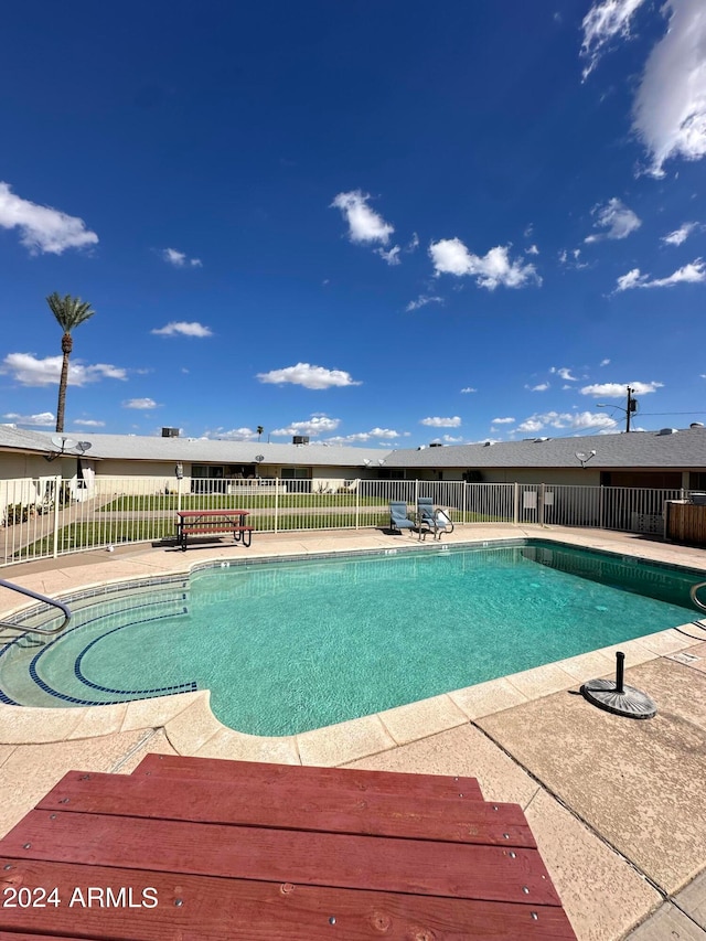 view of swimming pool featuring a patio area