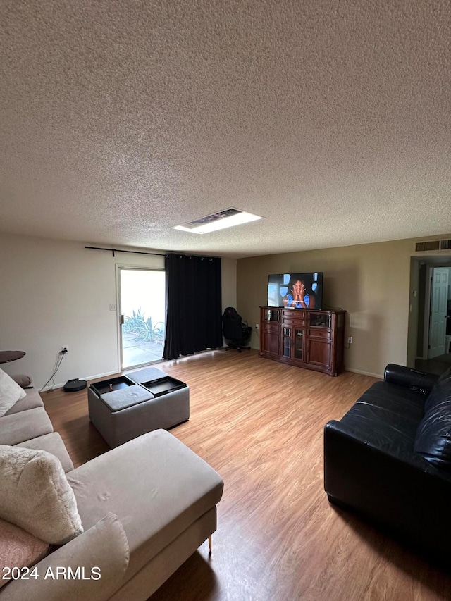 living room featuring a textured ceiling and hardwood / wood-style flooring