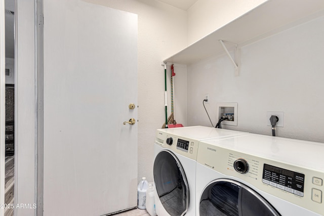 laundry room with washing machine and clothes dryer