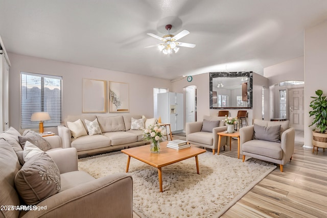 living room featuring ceiling fan and light hardwood / wood-style flooring