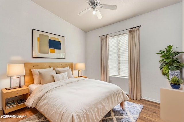 bedroom with ceiling fan and light wood-type flooring