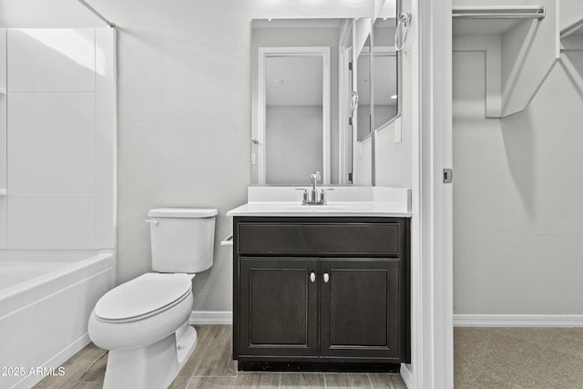 full bathroom with hardwood / wood-style flooring, vanity, shower / bathtub combination, and toilet