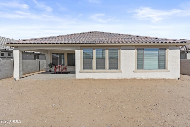 rear view of property featuring a patio area