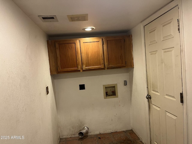 clothes washing area featuring cabinets and washer hookup