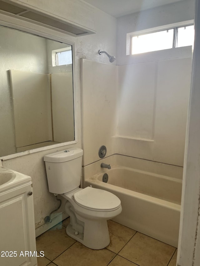 full bathroom with shower / washtub combination, vanity, tile patterned floors, and toilet