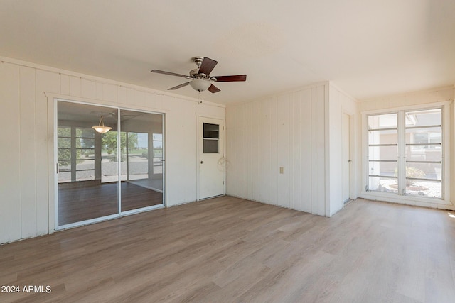 empty room featuring light wood-type flooring and a ceiling fan