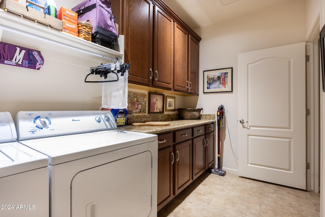 washroom featuring washer and clothes dryer and cabinets