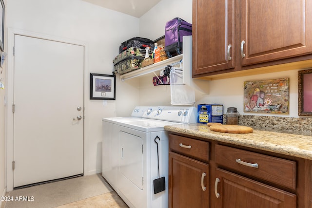 laundry room featuring washer and clothes dryer and light tile patterned flooring