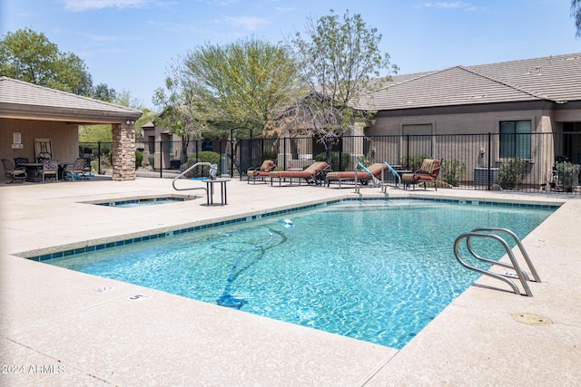 view of pool featuring a community hot tub and a patio