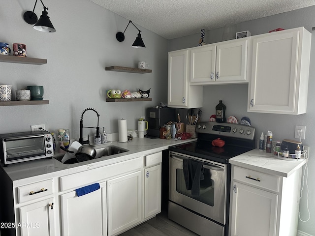 3646 N 67th Ave Unit 64, Phoenix, AZ 85033 - kitchen featuring open shelves, stainless steel electric range oven, a sink, a textured ceiling, and white cabinetry