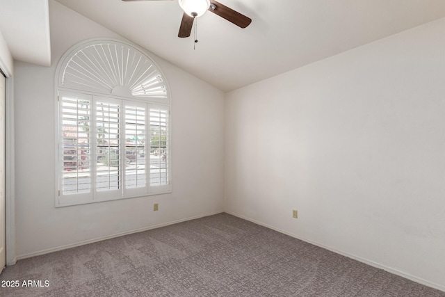 carpeted empty room featuring ceiling fan, baseboards, and lofted ceiling
