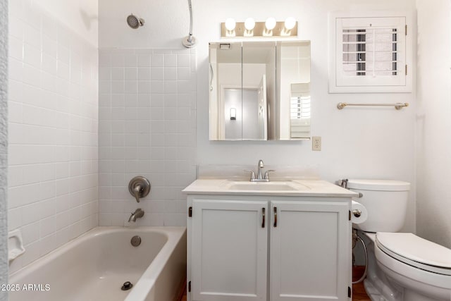 bathroom featuring toilet, vanity, and washtub / shower combination