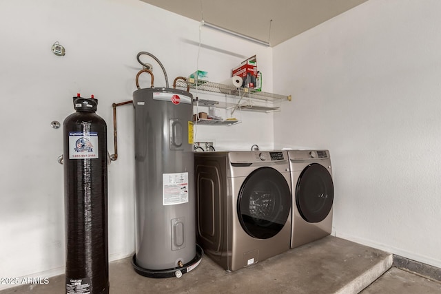 clothes washing area with laundry area, washing machine and dryer, and electric water heater