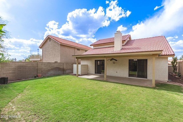back of property featuring a tiled roof, a fenced backyard, stucco siding, a ceiling fan, and a patio area