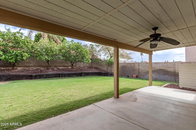 view of yard featuring a patio area, a fenced backyard, and a ceiling fan