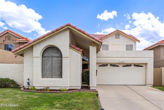 mediterranean / spanish house with a tile roof, fence, concrete driveway, a front lawn, and stucco siding