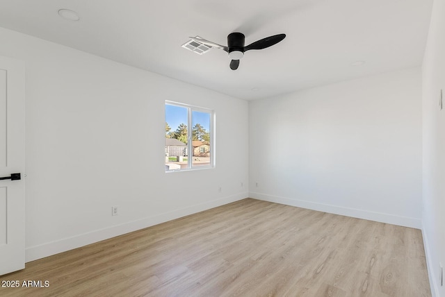 spare room featuring light wood-type flooring and ceiling fan