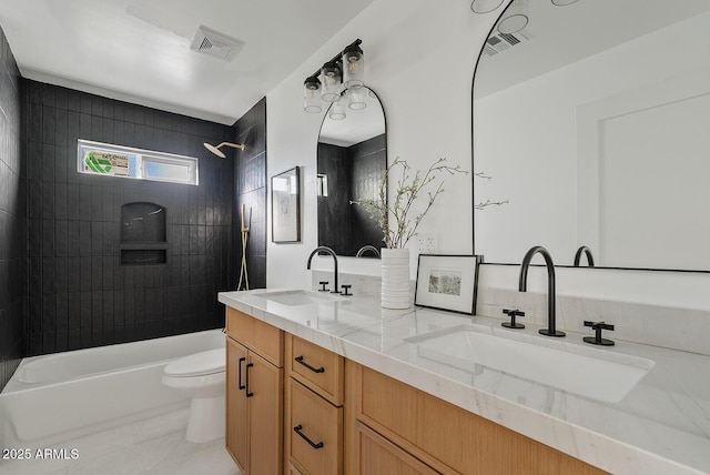 full bathroom with toilet, vanity, tile patterned flooring, and tiled shower / bath