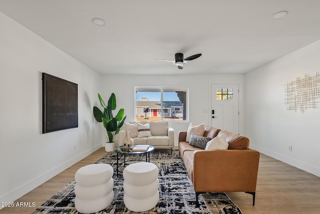 living room featuring light wood-type flooring and ceiling fan