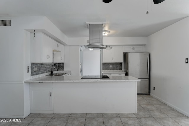 kitchen with sink, island range hood, stainless steel fridge, and kitchen peninsula