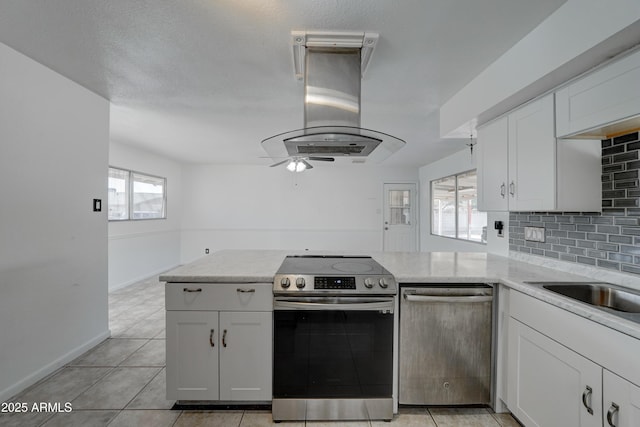 kitchen featuring white cabinetry, decorative backsplash, stainless steel appliances, and island exhaust hood