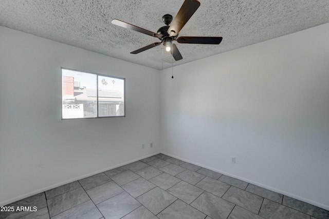 spare room with ceiling fan and a textured ceiling