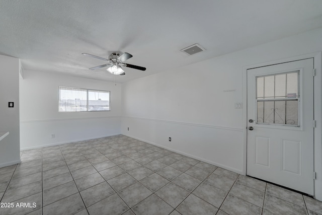 unfurnished room with a textured ceiling and ceiling fan