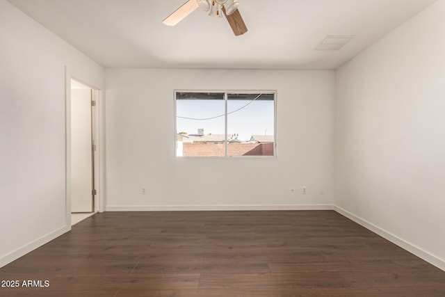 unfurnished room featuring dark wood-type flooring and ceiling fan