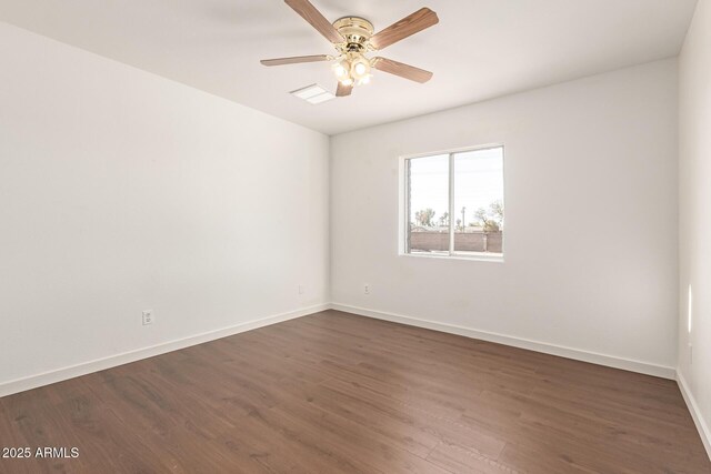 empty room with ceiling fan and dark hardwood / wood-style flooring