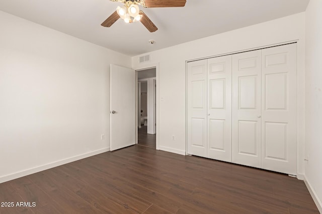 unfurnished bedroom with a closet, ceiling fan, and dark wood-type flooring