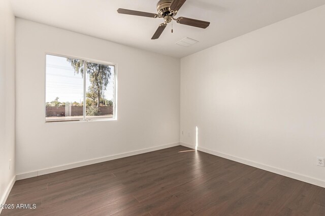 empty room featuring ceiling fan and dark hardwood / wood-style flooring