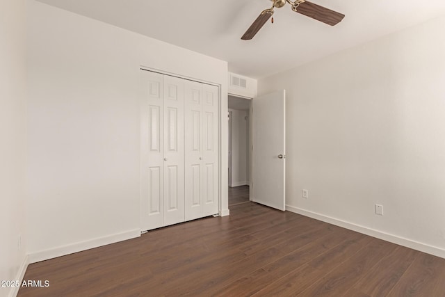 unfurnished bedroom featuring a closet, ceiling fan, and dark hardwood / wood-style floors