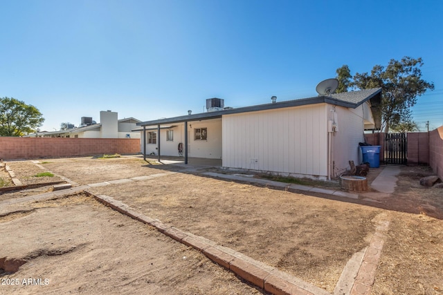 rear view of property with central air condition unit and a patio area