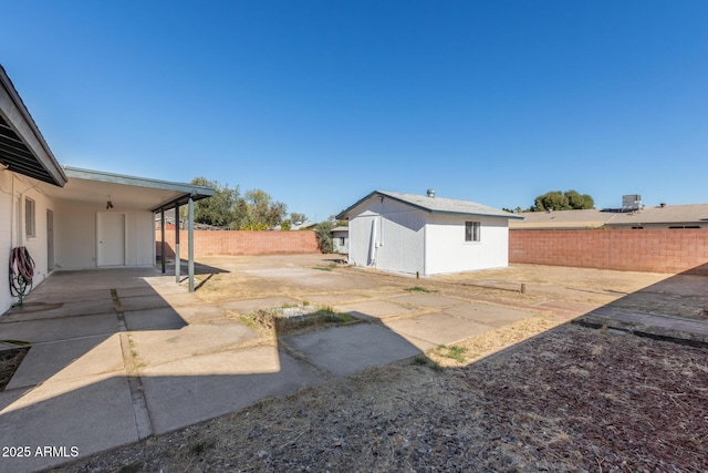 view of yard featuring an outbuilding and a patio