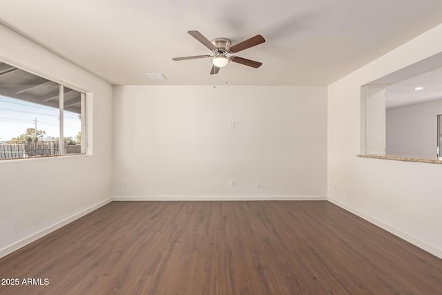 spare room featuring ceiling fan and dark hardwood / wood-style floors